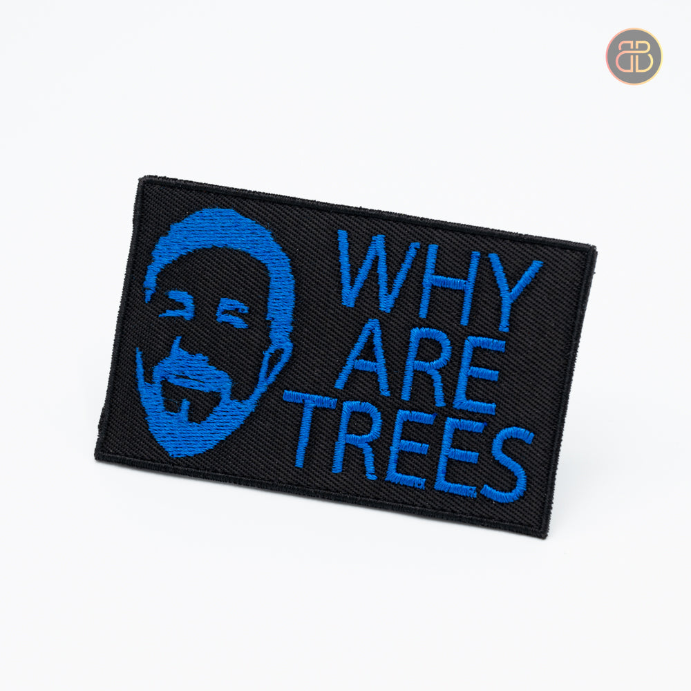 A discgolf patch with the text Why Are Trees