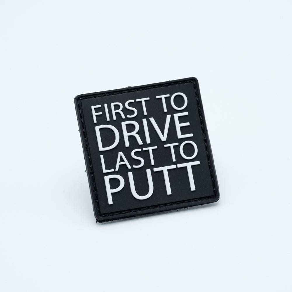 Disc golf pvc patch with the text first to drive last to putt