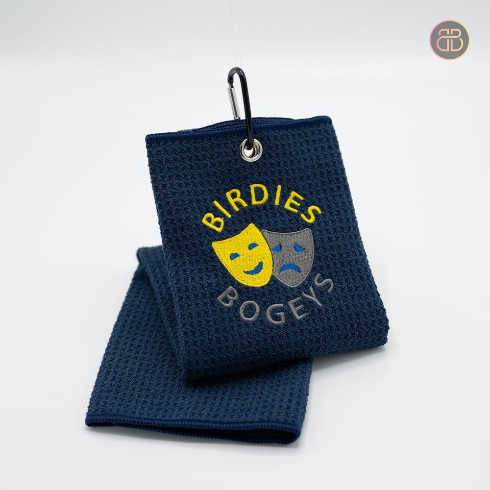 Discgolf towel with the text Birdies Bogeys and a happy face and a sad face