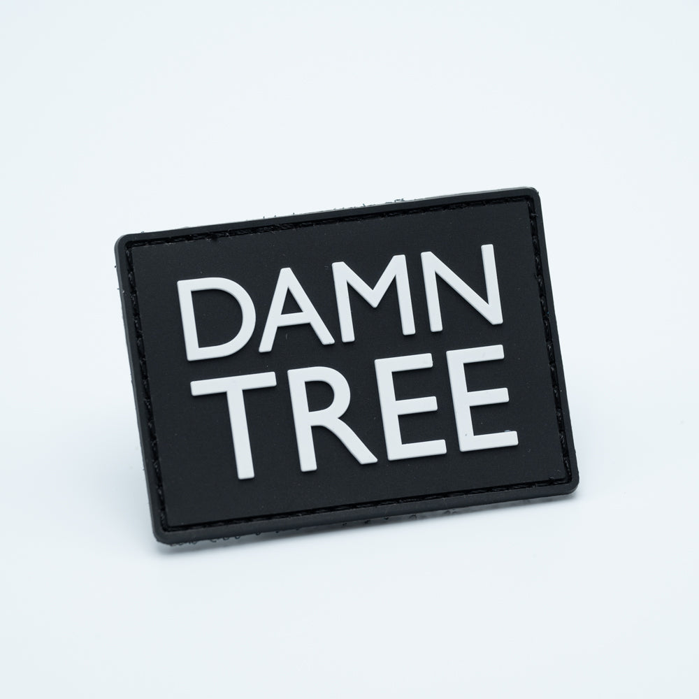 Disc golf PVC patch with the text DAMN TREE
