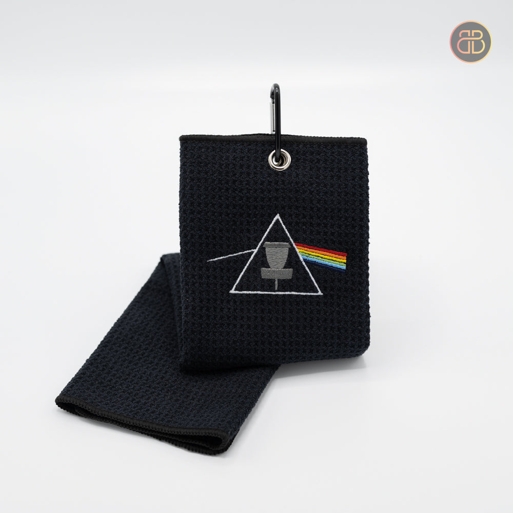 Discgolf towel with a basket in the middle surrounded by a triangle and a rainbow going from left to right