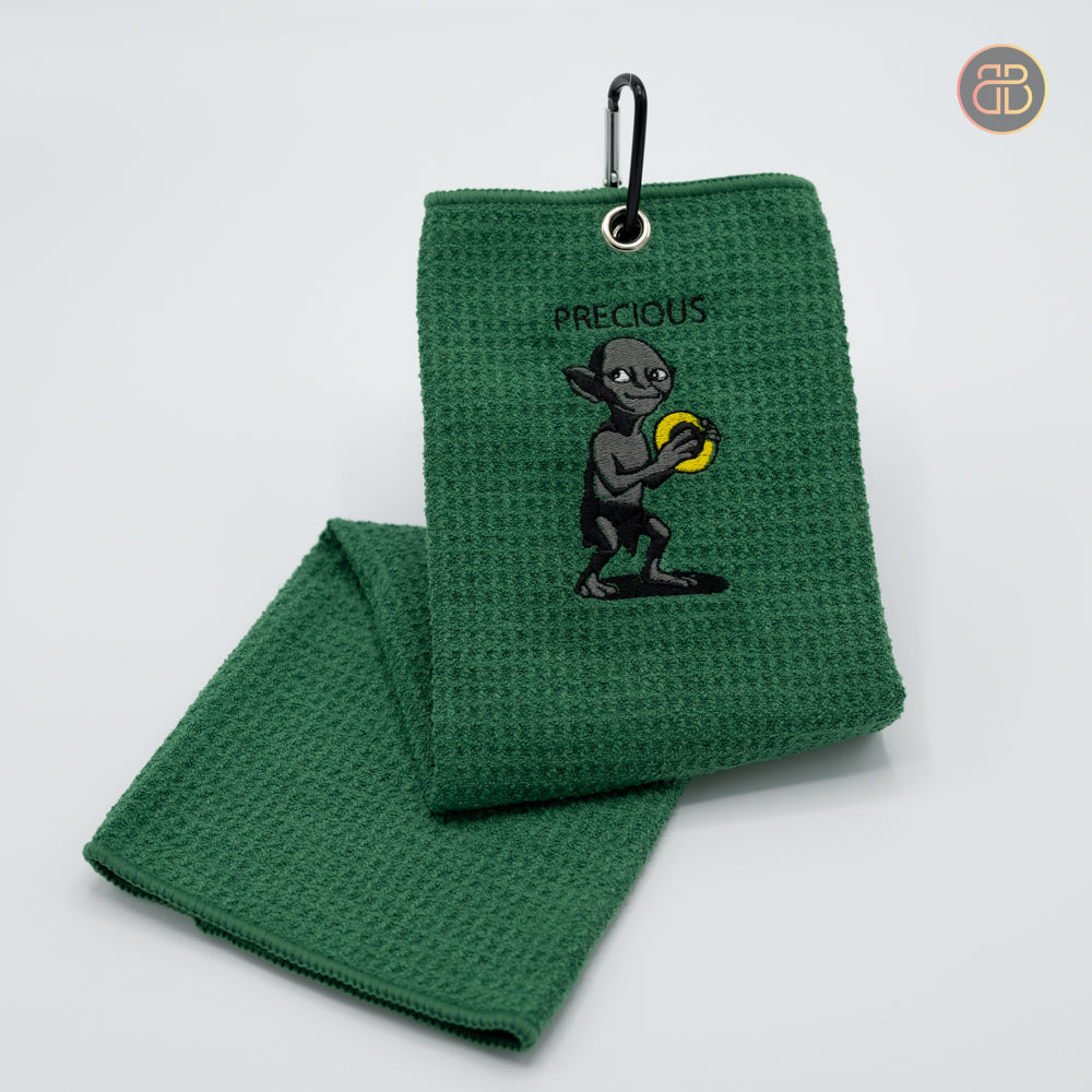 disc golf handduk towel with a person holding a discgolf disc in yellow and the text precious