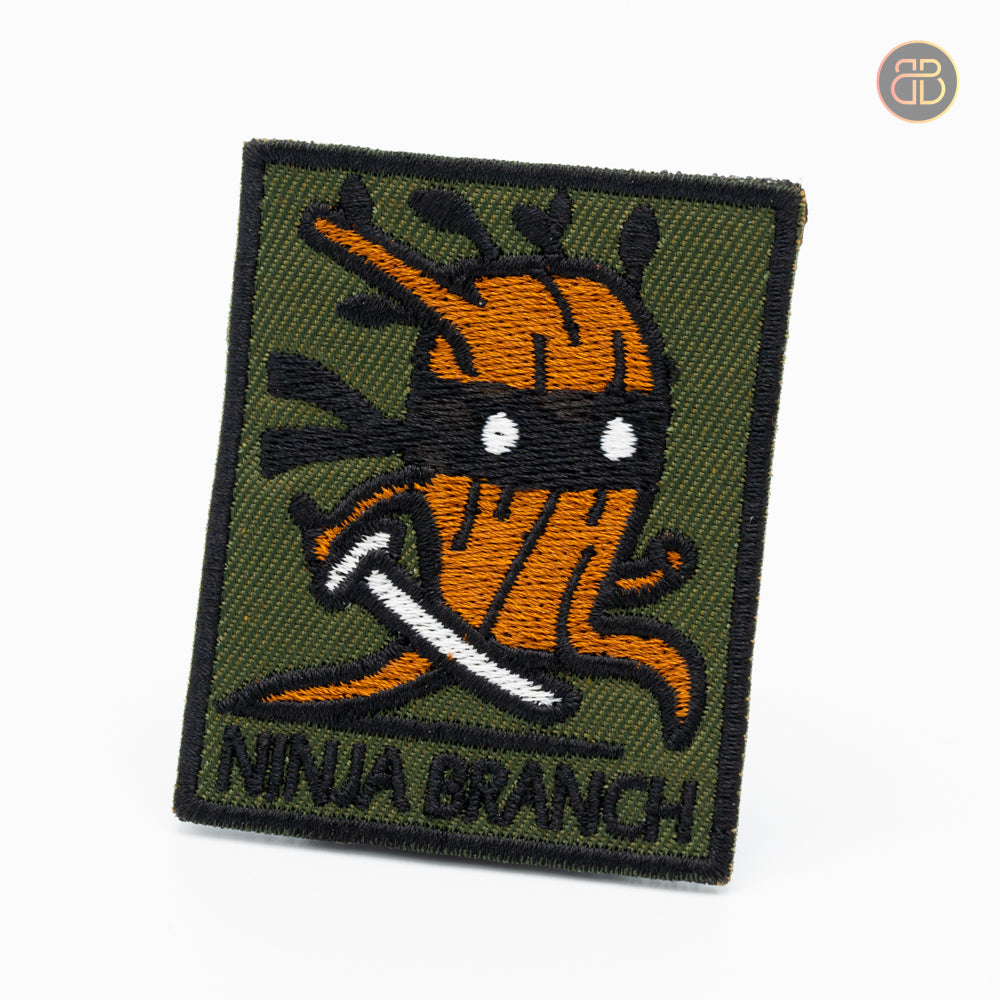 Discgolf patch with the text ninja branch and a wooden stick holding a ninja sword.