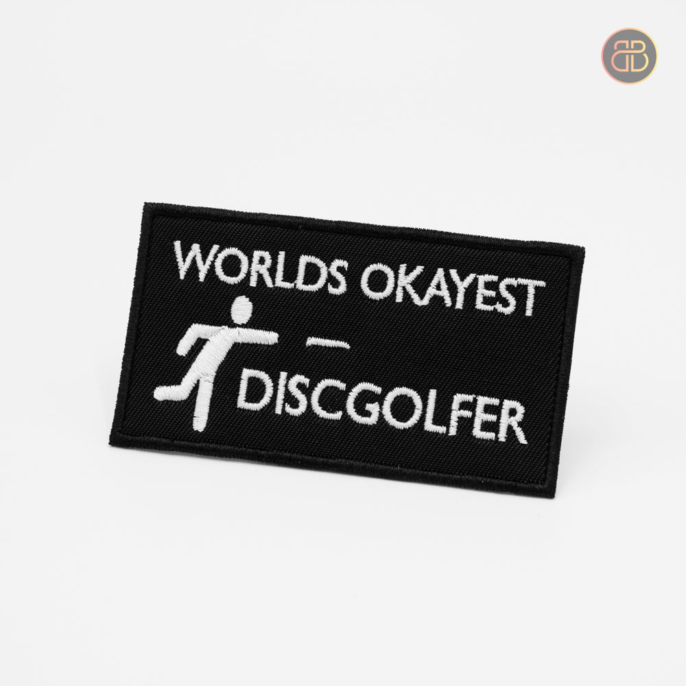 Discgolf patch with the text Worlds okayest Discgolfer