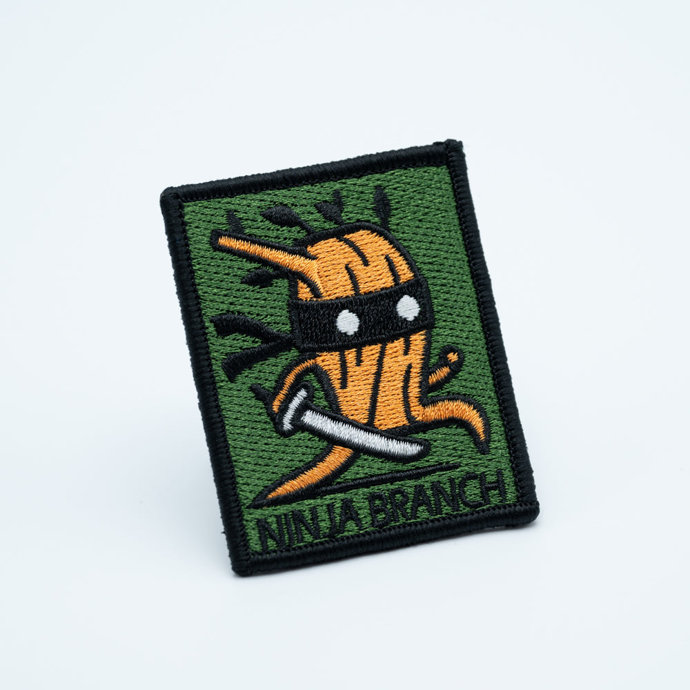 Discgolf patch with the text ninja branch and a wooden stick holding a ninja sword.