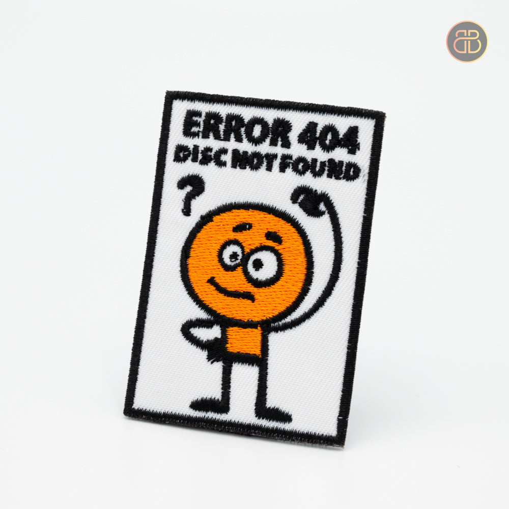 Discgolf patch and the text ERROR 404 DISC NOT FOUND and a cartoon 