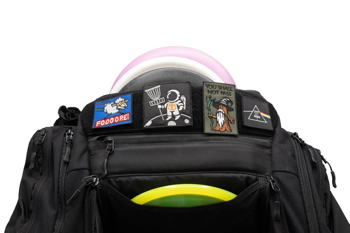 A discgolf bag with discgolf patches attached to it.